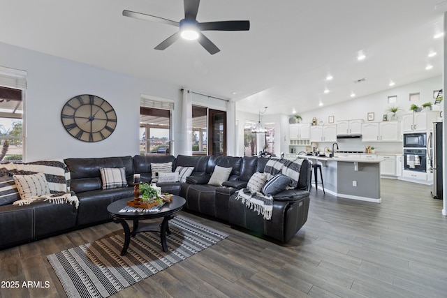 living room with sink, wood-type flooring, and ceiling fan