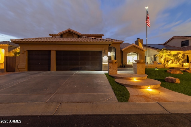 mediterranean / spanish-style house with a garage