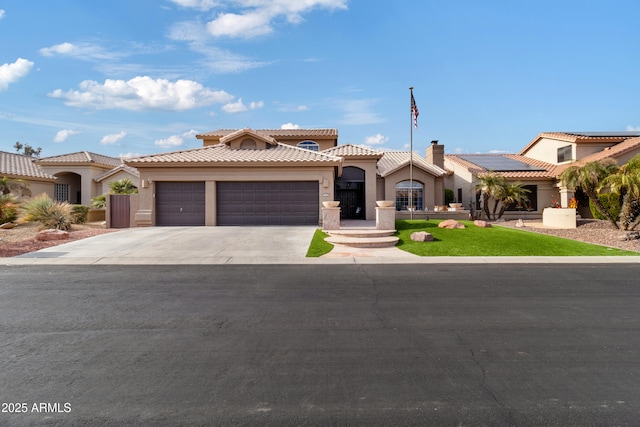 mediterranean / spanish house with a garage and solar panels