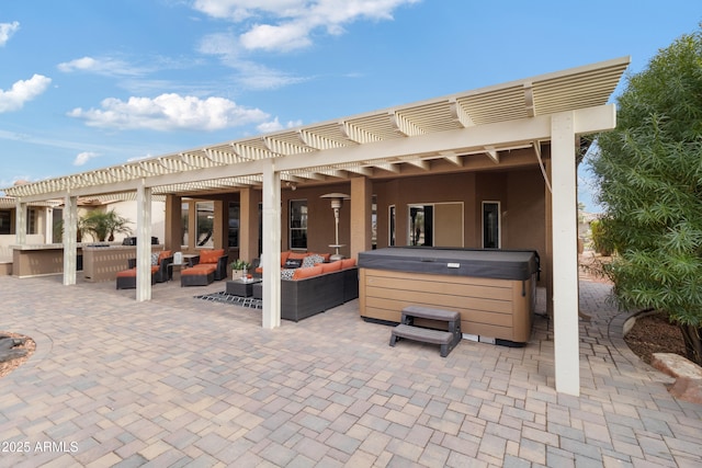 view of patio / terrace with outdoor lounge area, a hot tub, and a pergola