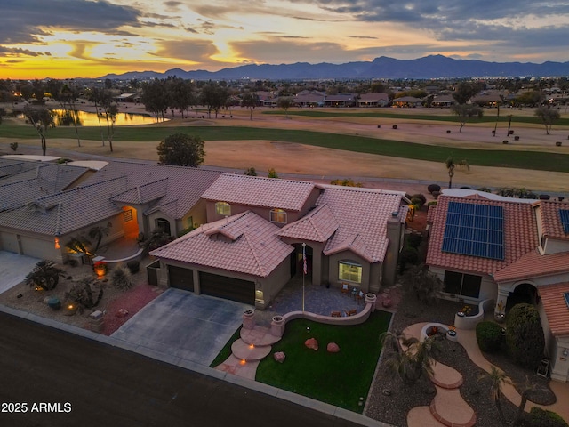 aerial view at dusk featuring a mountain view