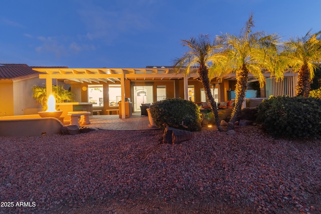 view of front facade with an outdoor living space, a patio, and a pergola