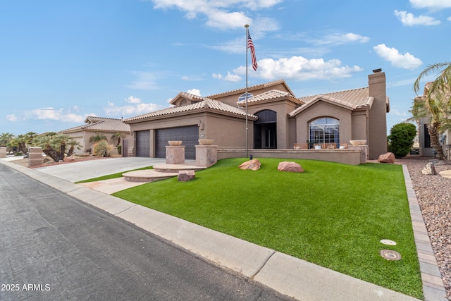 mediterranean / spanish house with a garage and a front lawn