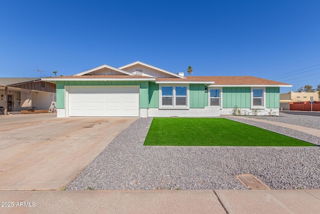 single story home featuring a garage and a front lawn