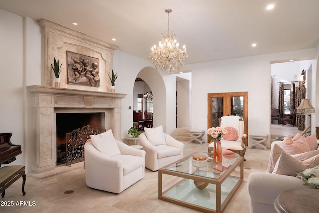 living room with an inviting chandelier and a high end fireplace