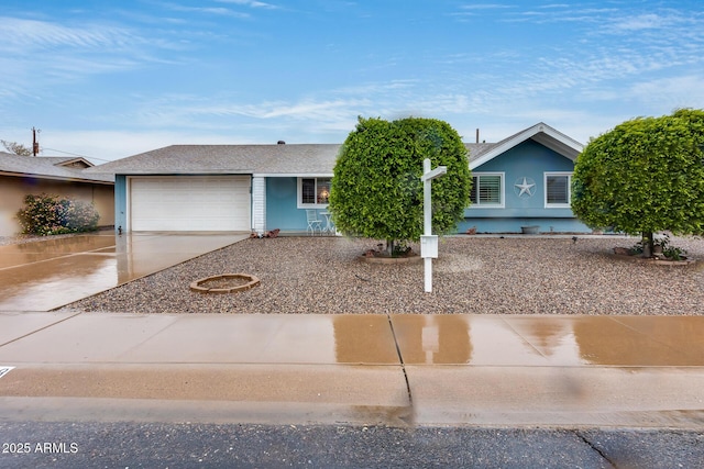 view of front of home featuring concrete driveway and a garage