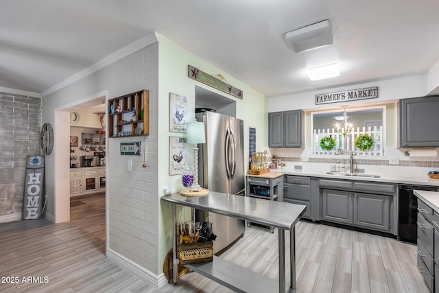 kitchen with tasteful backsplash, dishwasher, light countertops, gray cabinets, and a sink