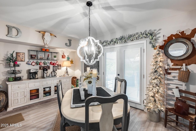 dining room featuring a notable chandelier and light wood finished floors