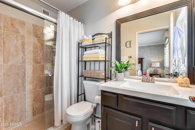 full bath featuring a stall shower, toilet, and vanity