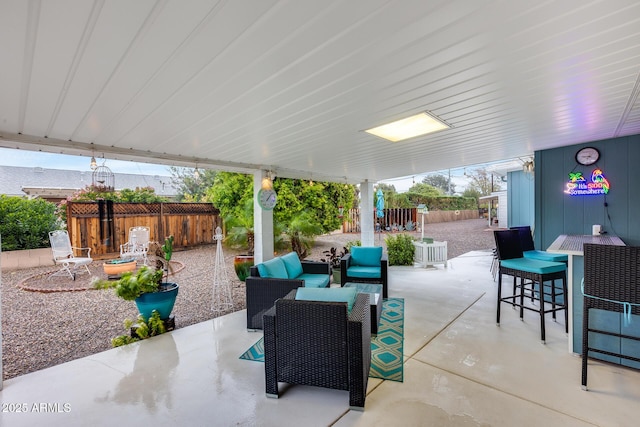 view of patio featuring an outdoor living space and fence