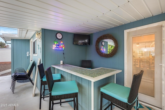 bar featuring a dry bar and concrete floors