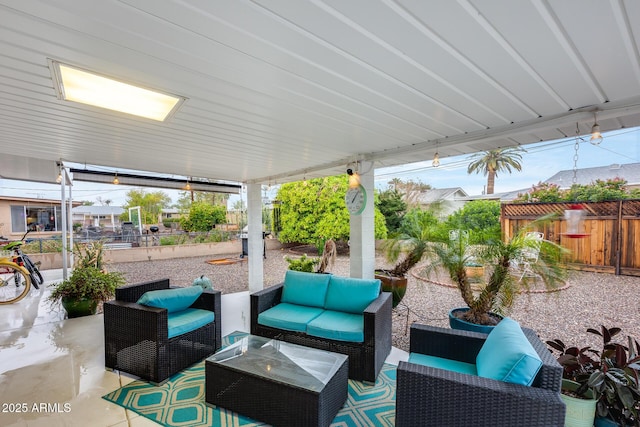 view of patio / terrace with an outdoor living space and fence