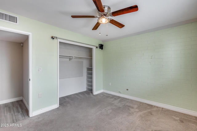 9928 W Hope Cir N, Sun City, AZ 85351 - unfurnished bedroom featuring carpet flooring, baseboards, a closet, and ceiling fan