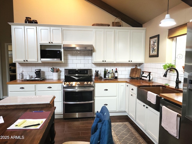 kitchen featuring stainless steel appliances, white cabinetry, hanging light fixtures, and wood counters