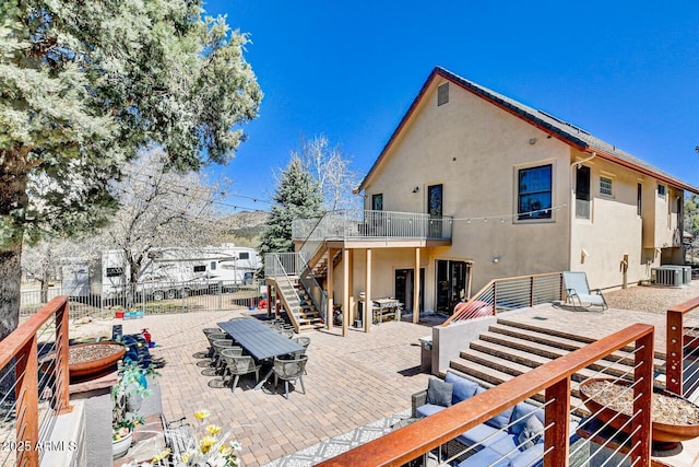 rear view of house featuring a patio and central AC