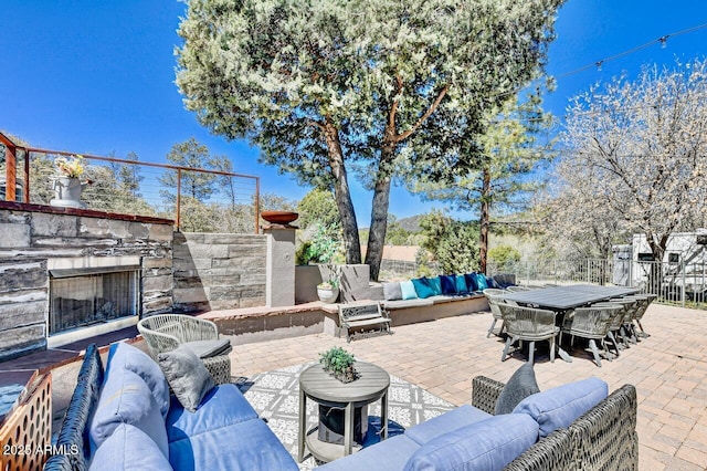 view of patio featuring an outdoor living space with a fireplace