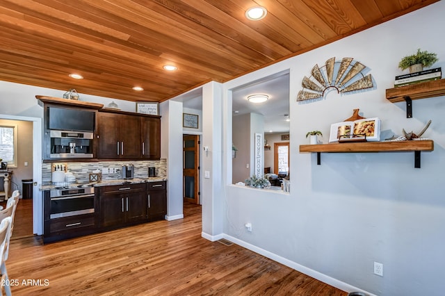 kitchen with wood ceiling, light wood-type flooring, stainless steel oven, dark brown cabinetry, and backsplash