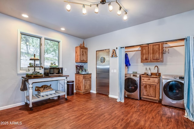 laundry area featuring washer / dryer and dark wood-type flooring