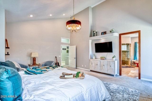 carpeted bedroom featuring connected bathroom and high vaulted ceiling