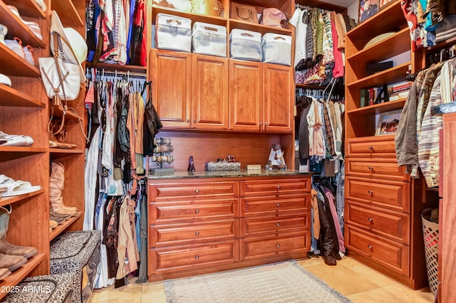 spacious closet with light tile patterned floors