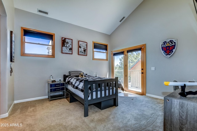 carpeted bedroom with high vaulted ceiling and access to exterior