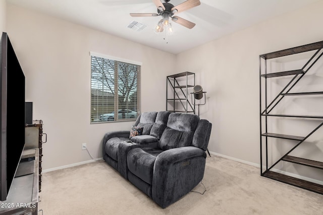 sitting room featuring light carpet and ceiling fan