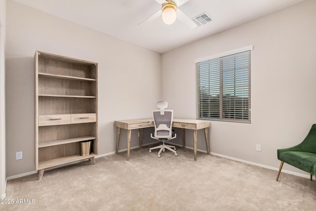 carpeted home office featuring ceiling fan