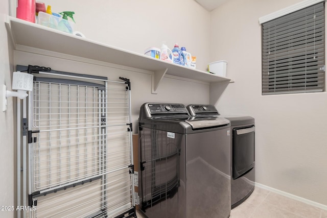 laundry room featuring independent washer and dryer and light tile patterned floors