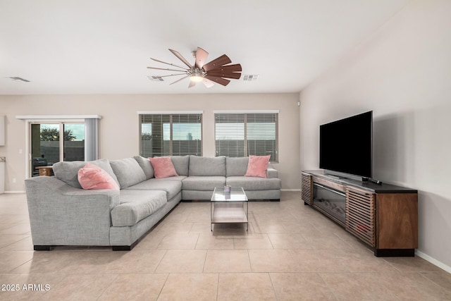 tiled living room with ceiling fan