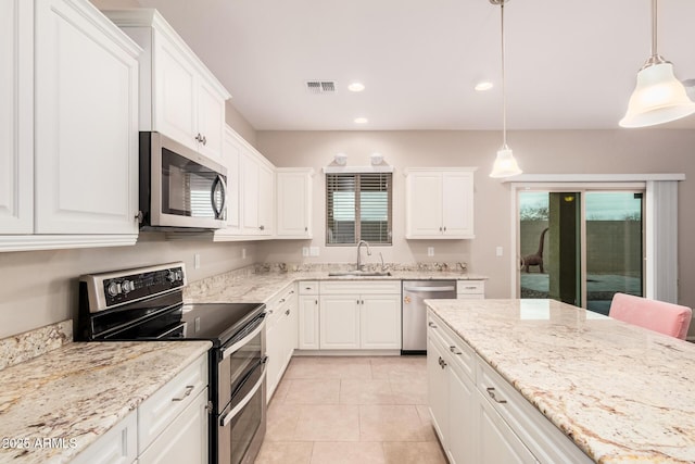 kitchen with stainless steel appliances, decorative light fixtures, sink, and white cabinets