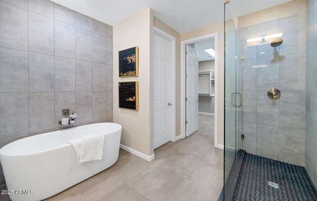 16255 E Ridgeline Dr, Fountain Hills, AZ 85268 - full bath with tile patterned flooring, tile walls, baseboards, a shower stall, and a soaking tub