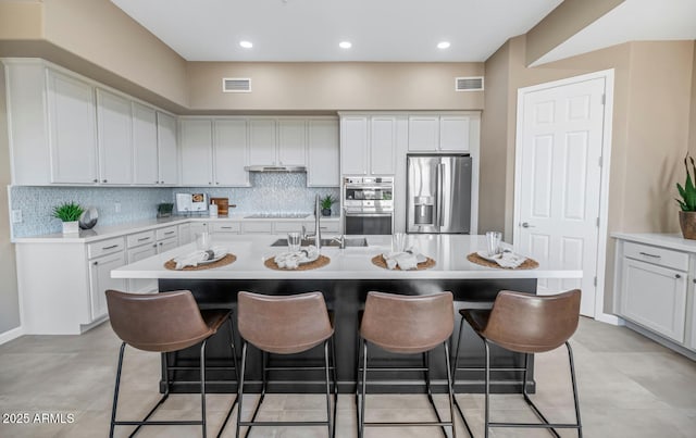 16255 E Ridgeline Dr, Fountain Hills, AZ 85268 - kitchen featuring decorative backsplash, a breakfast bar area, visible vents, and appliances with stainless steel finishes