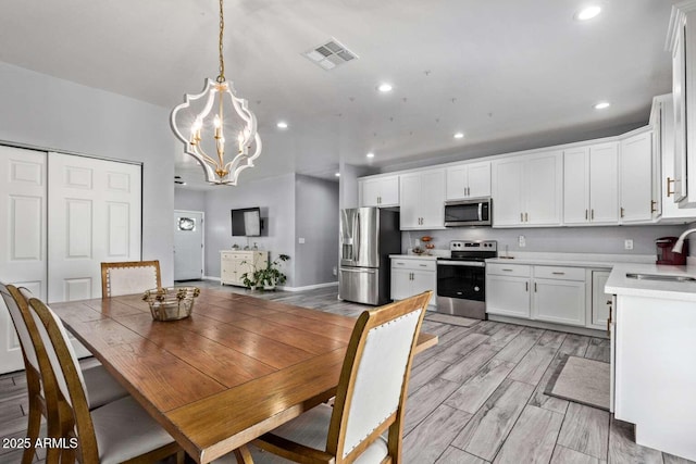 dining room with a notable chandelier and sink