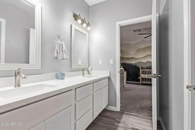 bathroom featuring hardwood / wood-style floors, vanity, and ceiling fan