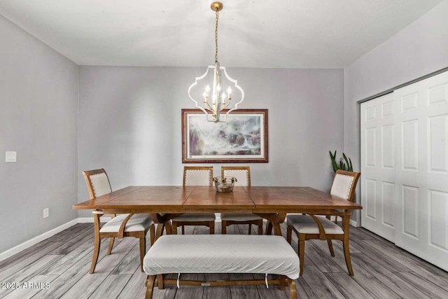 dining room featuring a chandelier and wood-type flooring