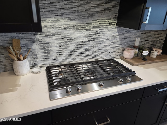 2316 N Crestwood Dr, Florence, AZ 85132 - room details featuring dark cabinetry, tasteful backsplash, and stainless steel gas stovetop