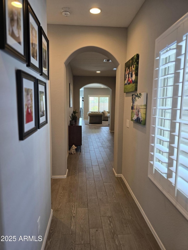 2316 N Crestwood Dr, Florence, AZ 85132 - hallway with recessed lighting, arched walkways, dark wood-style flooring, and baseboards