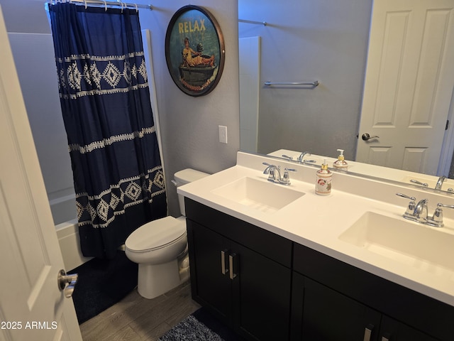2316 N Crestwood Dr, Florence, AZ 85132 - bathroom featuring toilet, shower / bath combo with shower curtain, a sink, and wood finished floors