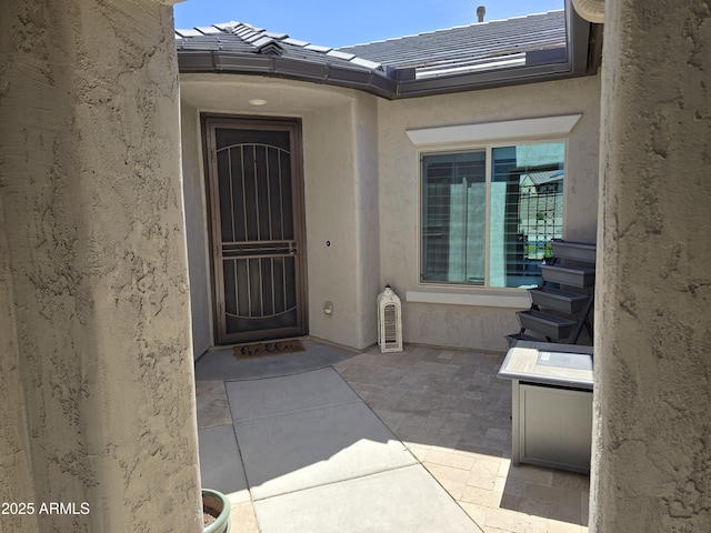2316 N Crestwood Dr, Florence, AZ 85132 - property entrance with a tiled roof, a patio, and stucco siding