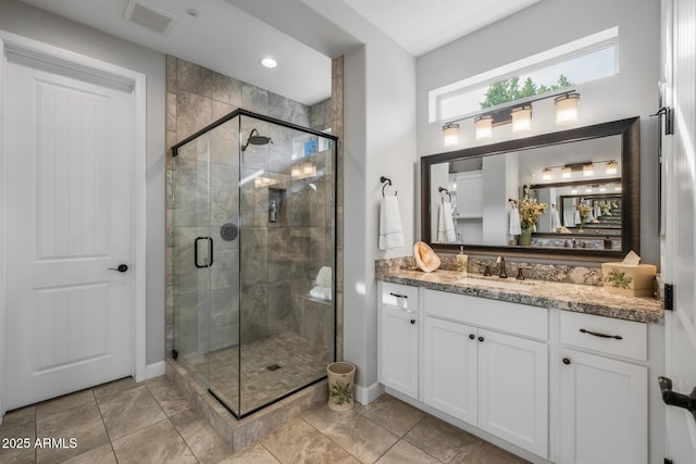 bathroom featuring vanity and a shower with shower door