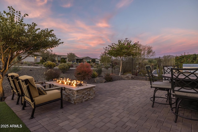 patio terrace at dusk featuring a fire pit