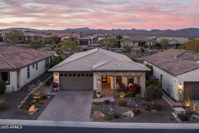 view of front of house with a garage and a mountain view