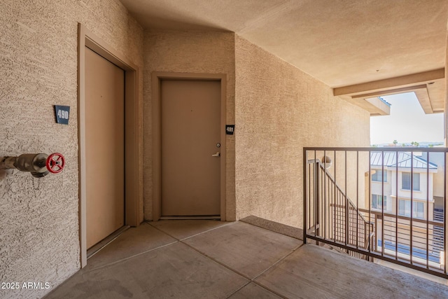 1701 E Colter St Unit 491, Phoenix, AZ 85016 - view of exterior entry with stucco siding and a balcony