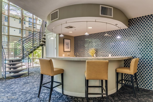 1701 E Colter St Unit 491, Phoenix, AZ 85016 - kitchen with plenty of natural light, carpet flooring, and a kitchen bar
