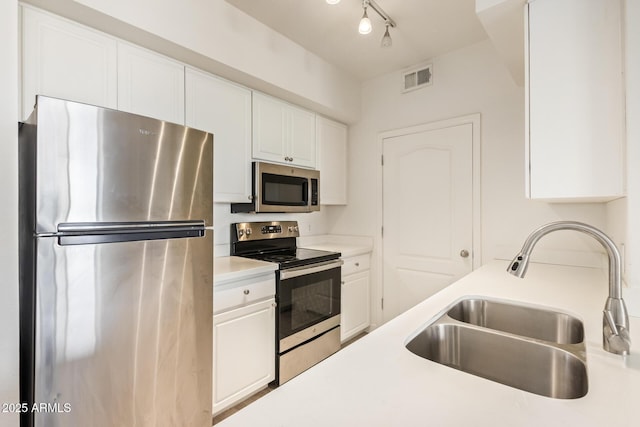 1701 E Colter St Unit 491, Phoenix, AZ 85016 - kitchen featuring stainless steel appliances, a sink, and white cabinets