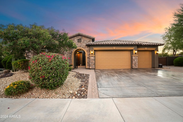 mediterranean / spanish house featuring a garage