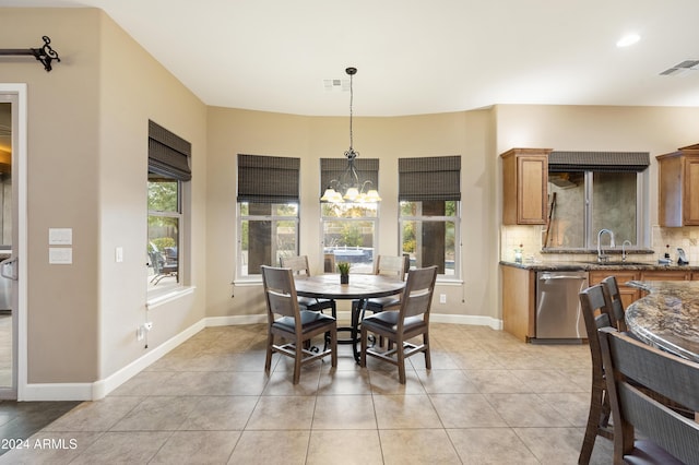 2378 N 158th Dr, Goodyear, AZ 85395 - dining room with plenty of natural light, a chandelier, light tile patterned floors, and baseboards