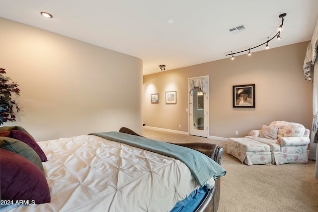 carpeted bedroom with track lighting