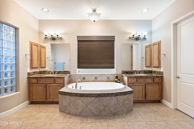 bathroom featuring vanity, tile patterned floors, and tiled tub