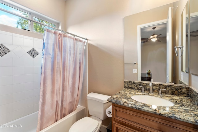 full bathroom with toilet, vanity, shower / bath combo with shower curtain, and ceiling fan